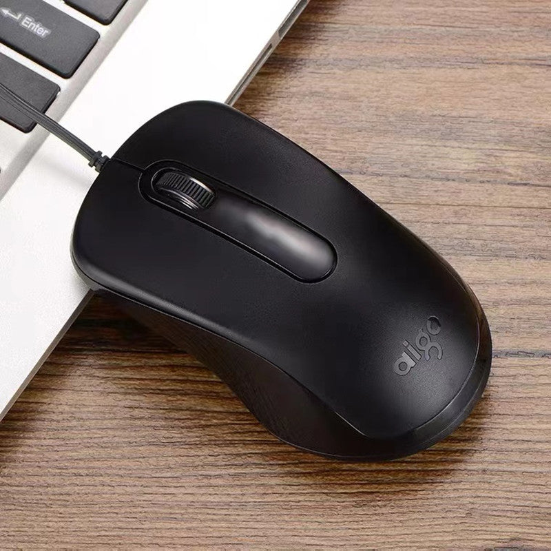 Cordnest – Black wired mouse resting on a wooden desk beside the edge of a laptop keyboard, cable running up to the left