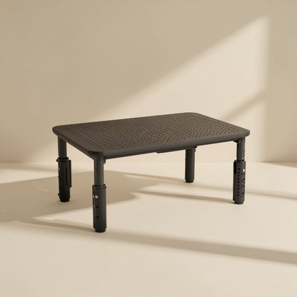Screenlift – Black stand with uneven leg heights, showing the perforated tube legs and drilled adjustment holes up close