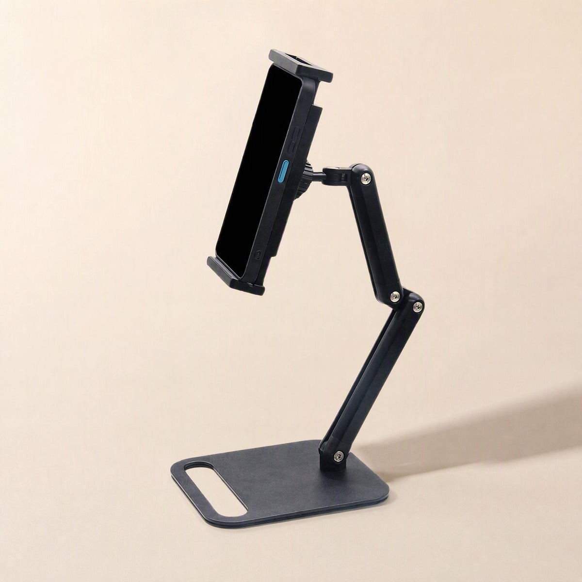 Carbonprop Foldable Carbon Steel Phone Stand holding a phone upright on its flat black base with two-segment arm