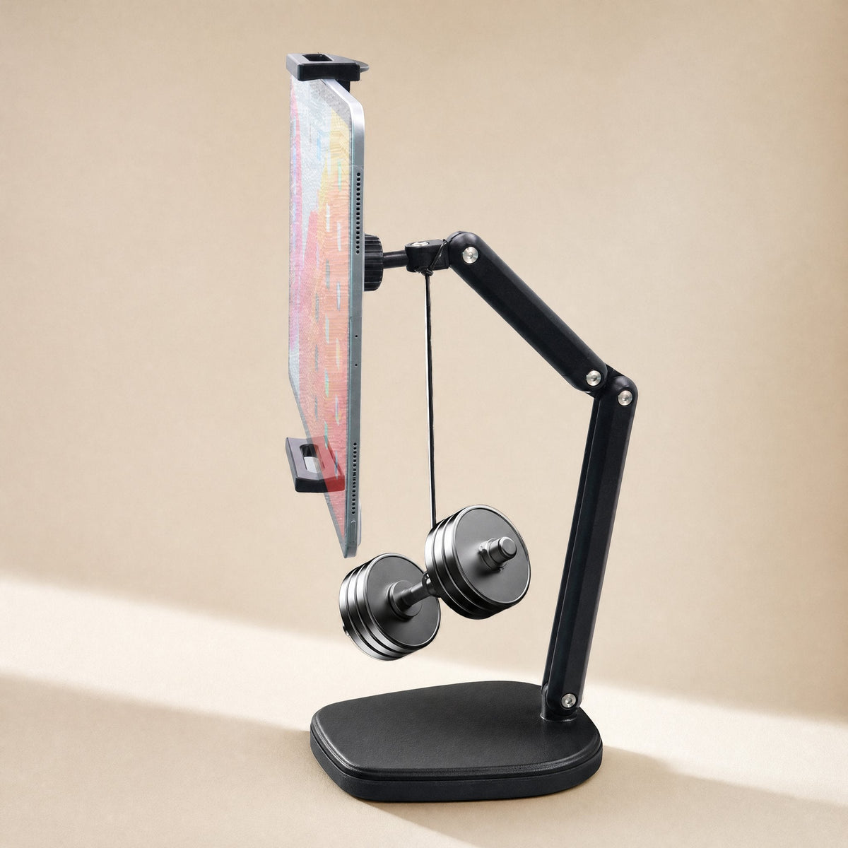 Carbonprop – Black foldable stand holding a tablet at an angle with a small dumbbell hanging from the arm on a cord