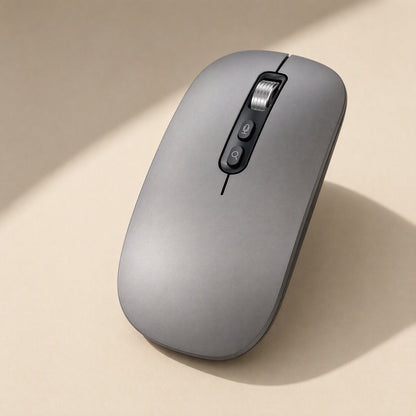 Voiceclick – Gray mouse seen at an angle, showing scroll wheel and two side buttons in soft shadow