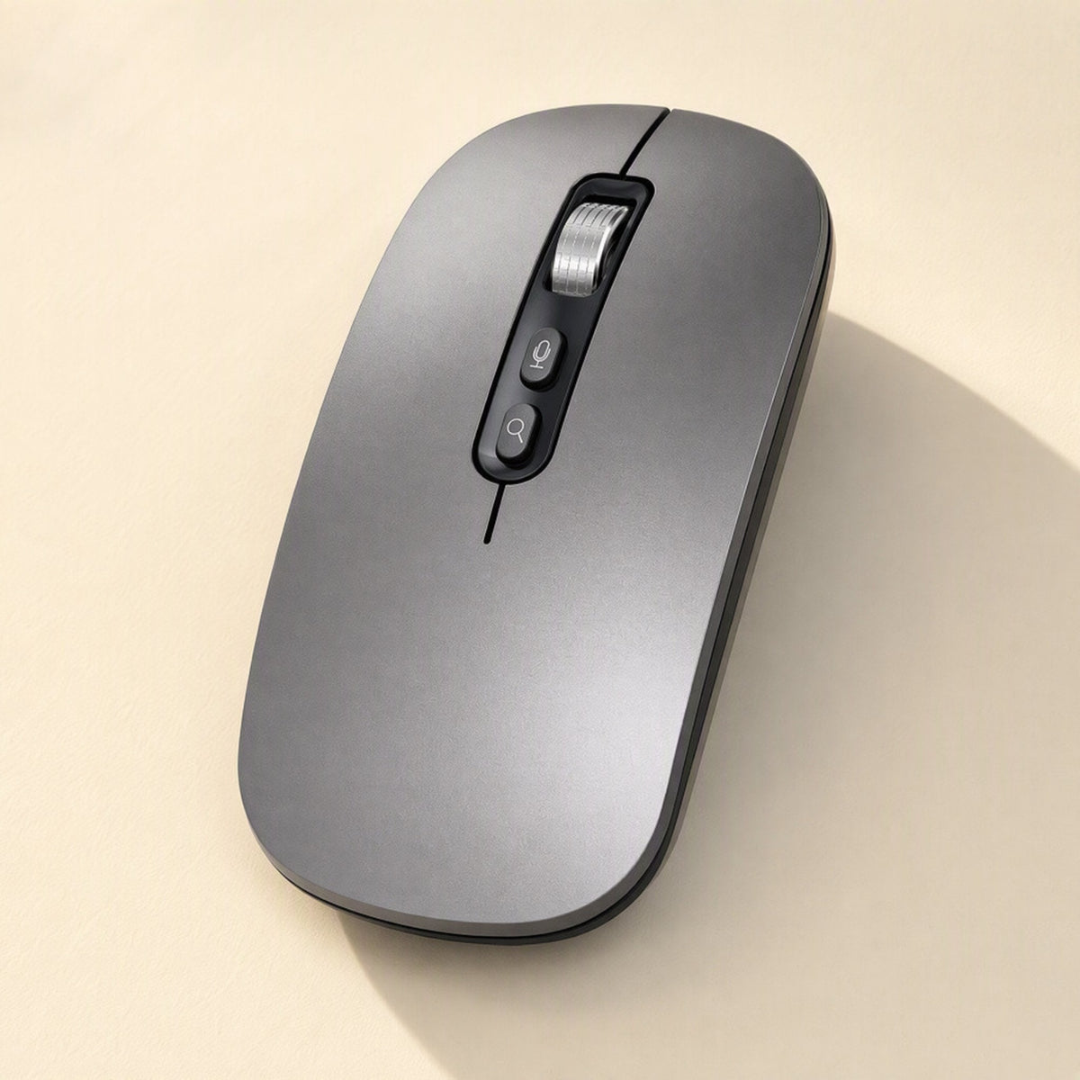 Voiceclick – Gray mouse from above at a slight angle on a beige surface, with a curved shadow to the right