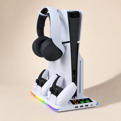 Coolbase – White cooling stand holding a PS5 upright, with a headset hung on top, two controllers charging and USB ports