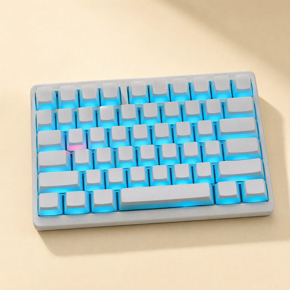 Keyshimmer Translucent PBT keycaps in white on a compact keyboard with blue backlight, seen from above