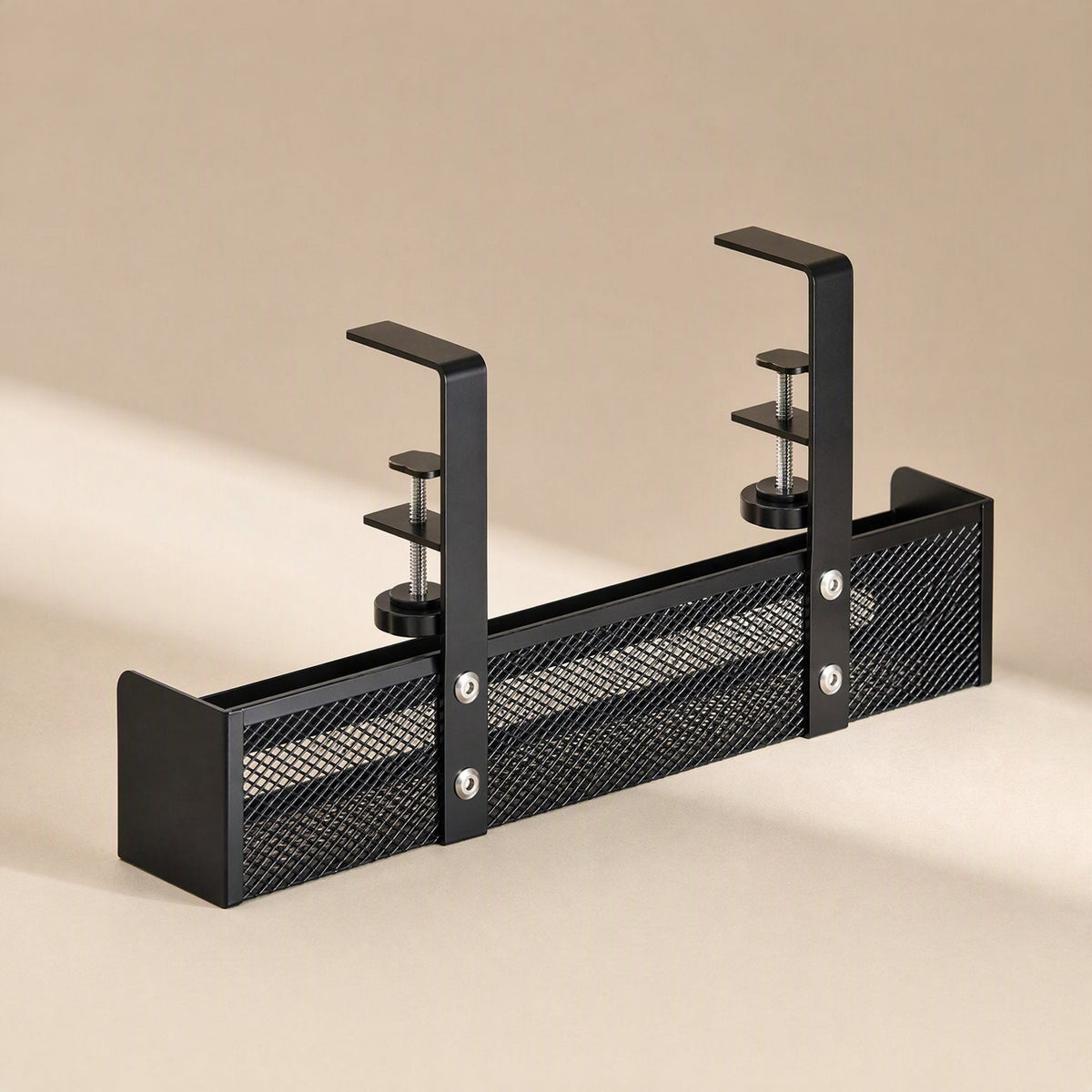 Desktrack – Black mesh wire basket cable rack with two side clamps, shown straight on against a beige background