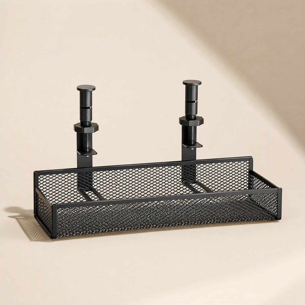 Desktrack – Under-desk cable organizer basket seen from above with clamp screws and mesh sides visible