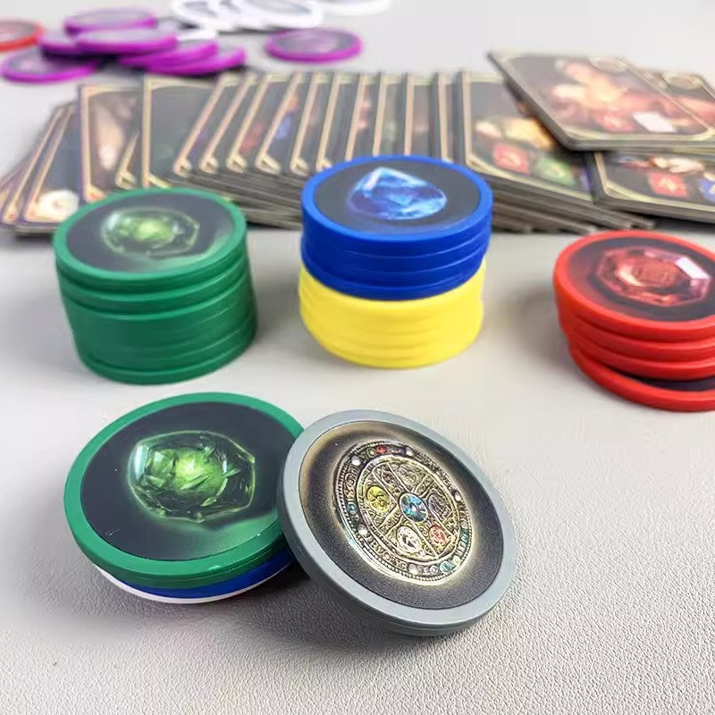 Gemloom – Close-up of green, blue, yellow, red and gray gem tokens with a card layout in the background