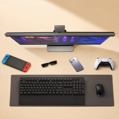 Tapbar – Light bar clipped on top of a monitor above a keyboard, mouse, game controller, phone and sunglasses