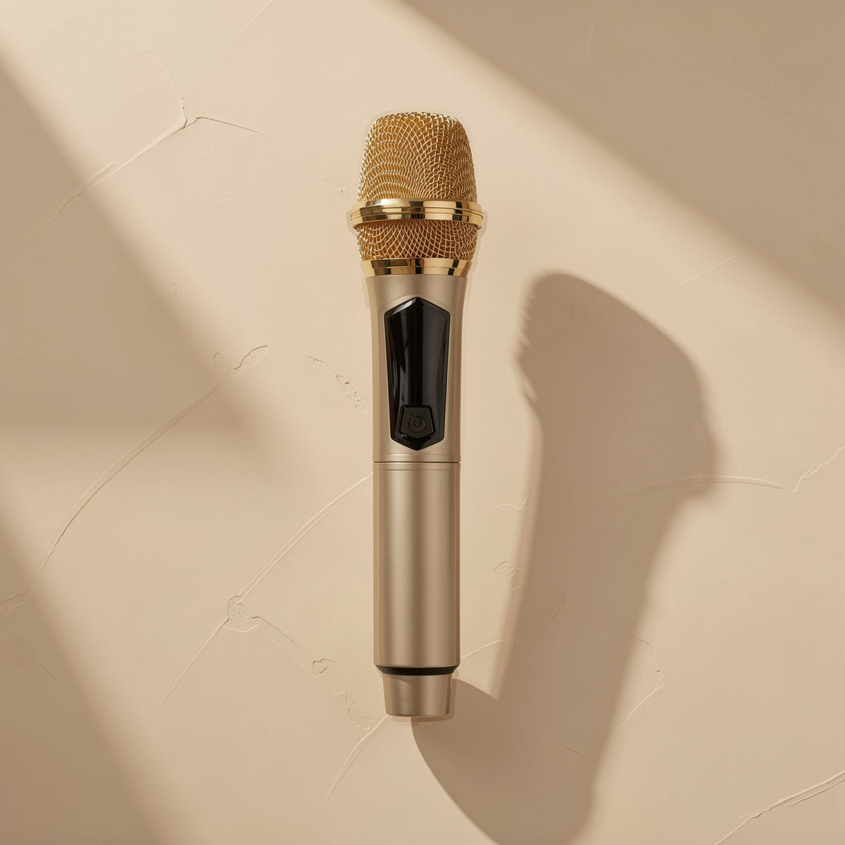 Voicevolt Wireless Microphone in champagne gold with a gold mesh head, shown from above on a beige wall