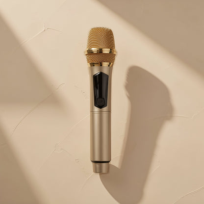 Voicevolt Wireless Microphone in champagne gold with a gold mesh head, shown from above on a beige wall