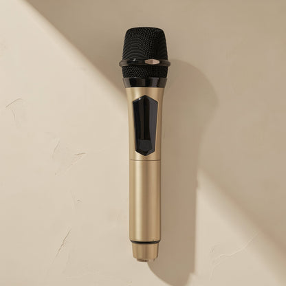Voicevolt – Gold handheld microphone with black mesh head, power button and a textured base, mounted against a beige wall