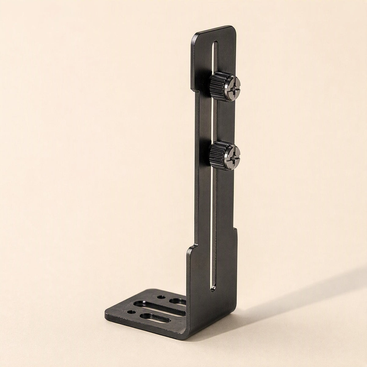 Cornerhold – Black L-shaped bracket standing upright, showing the slotted upright with two thumbscrews and slotted base