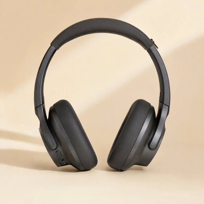 Caseguard – Black silicone covers on Soundcore Q20i headphones, front view against a cream backdrop