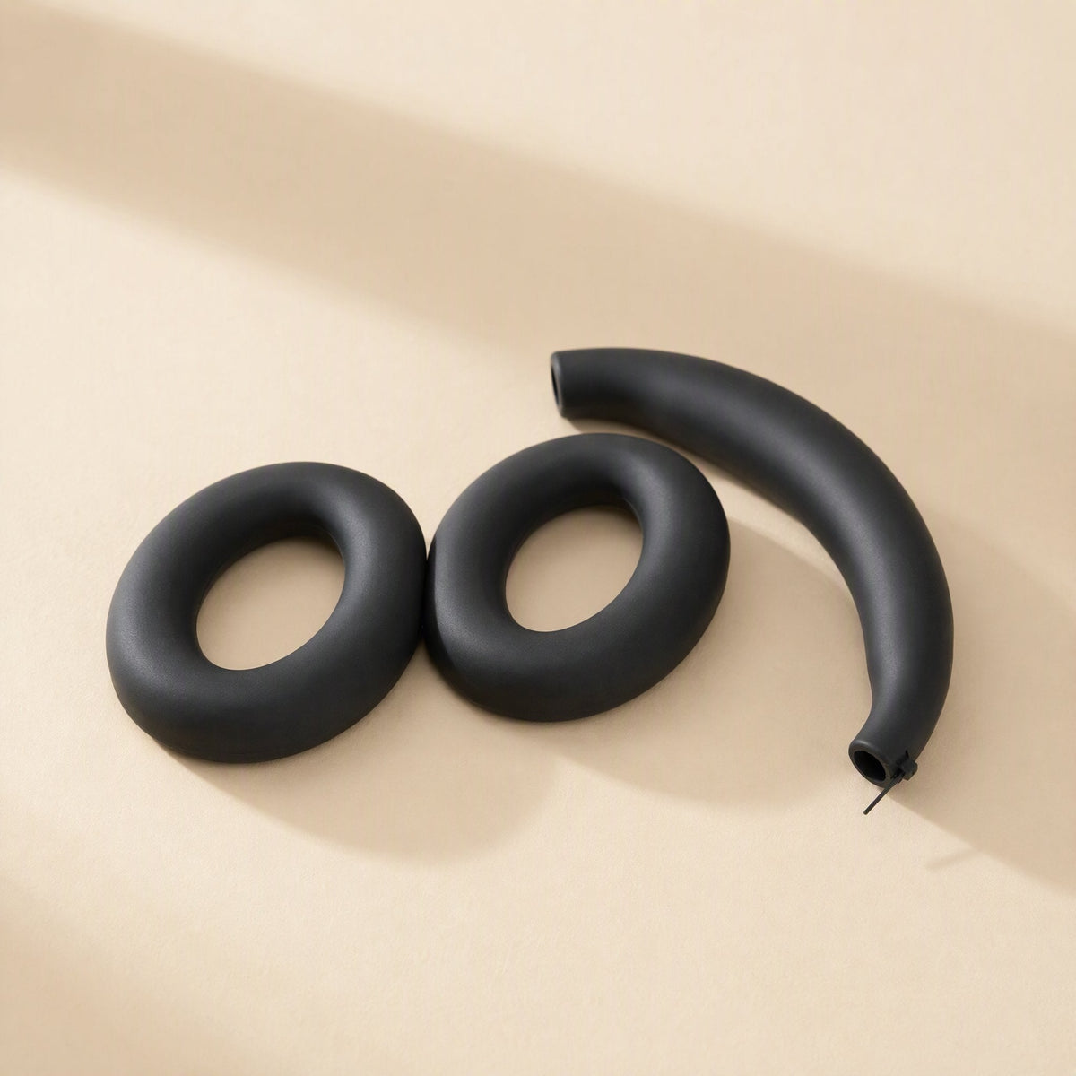 Caseguard – Black silicone earcup rings and headband cover laid flat, with a zipper pull at the headband end