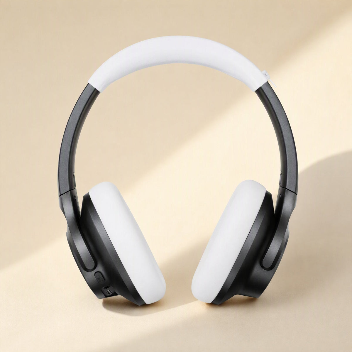 Caseguard – White silicone covers fitted on black over-ear headphones, front view with soft light
