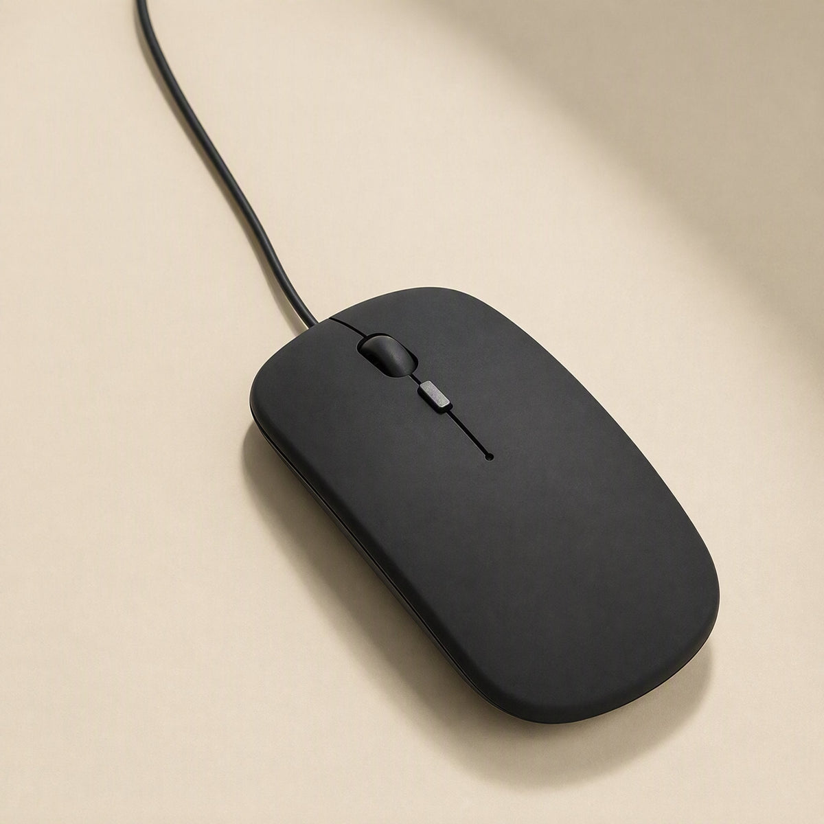 Clickfour – Overhead view of black wired mouse with cable running up and away, scroll wheel and button near the top