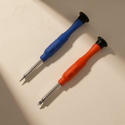 Bitdriver – Blue and orange screwdrivers angled on a beige surface, showing pointed bit tips on silver shafts