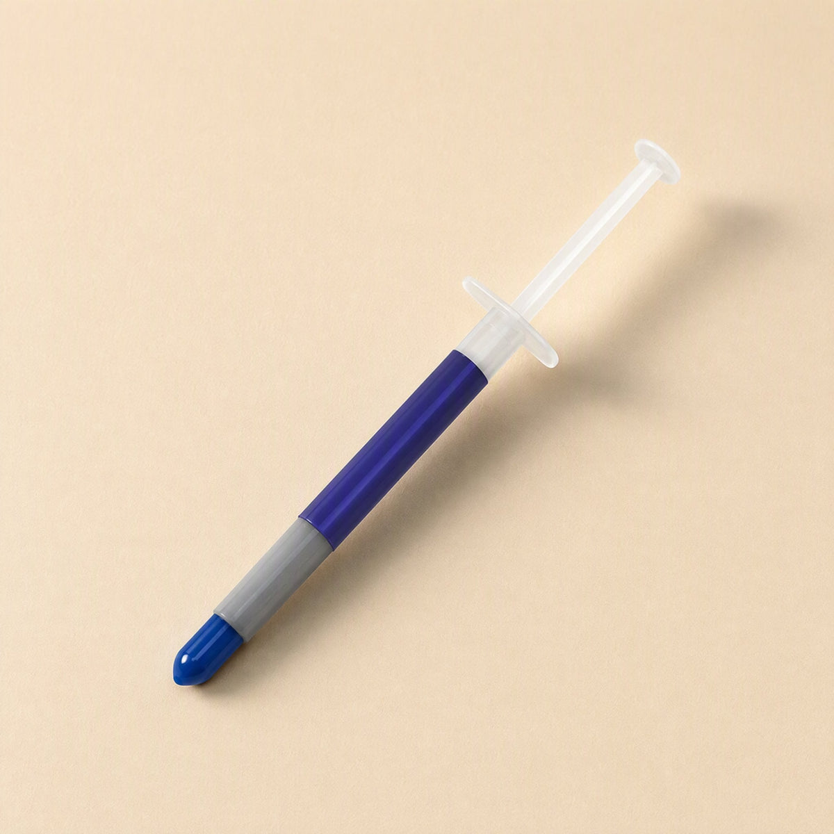 Thermspread silicone thermal paste syringe with blue barrel and cap on a cream background