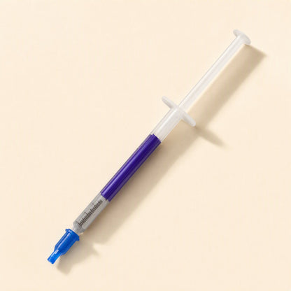 Thermspread – Syringe with the blue cap removed and placed on the tip, showing the purple paste inside the barrel