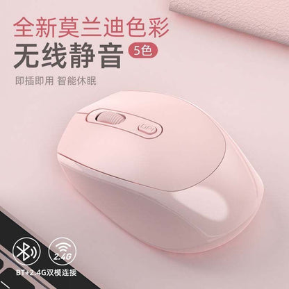 Quietgrip – Pink wireless mouse resting on a pink surface with a laptop edge, Bluetooth and 2.4G icons at the bottom