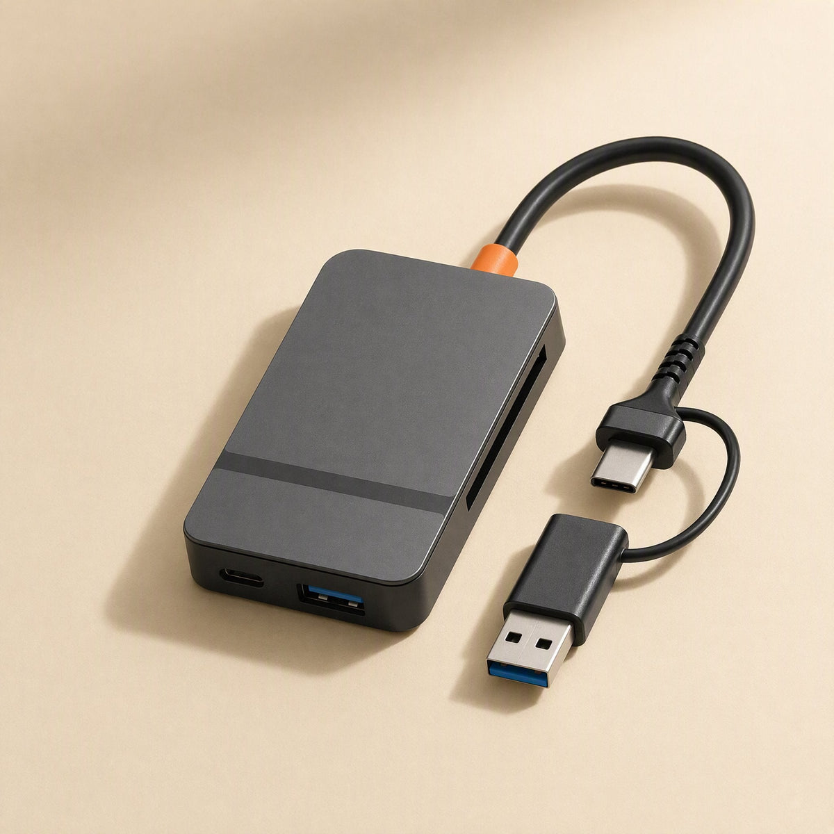 Cardlink USB-C Multi-Card Reader in dark gray with orange cable tip, seen from above with dual-plug cable