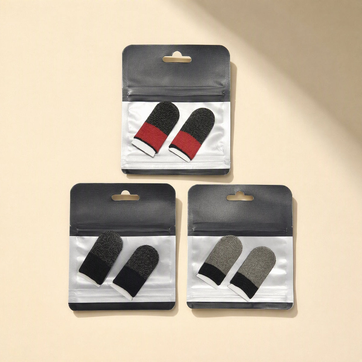 Gamegrip Touchscreen Finger Sleeve in three packs: red, black and grey striped pairs in clear bags