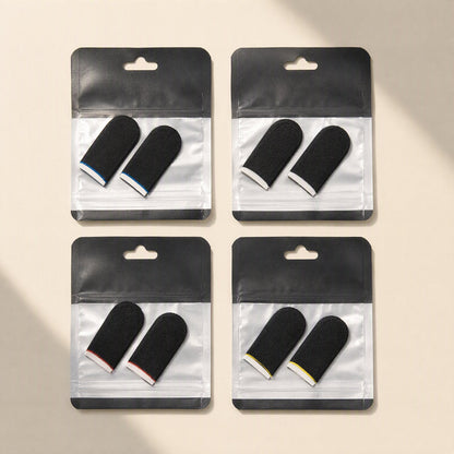 Gamegrip – Four packs of black finger sleeves with blue, white, red and yellow trim in clear zip bags on beige