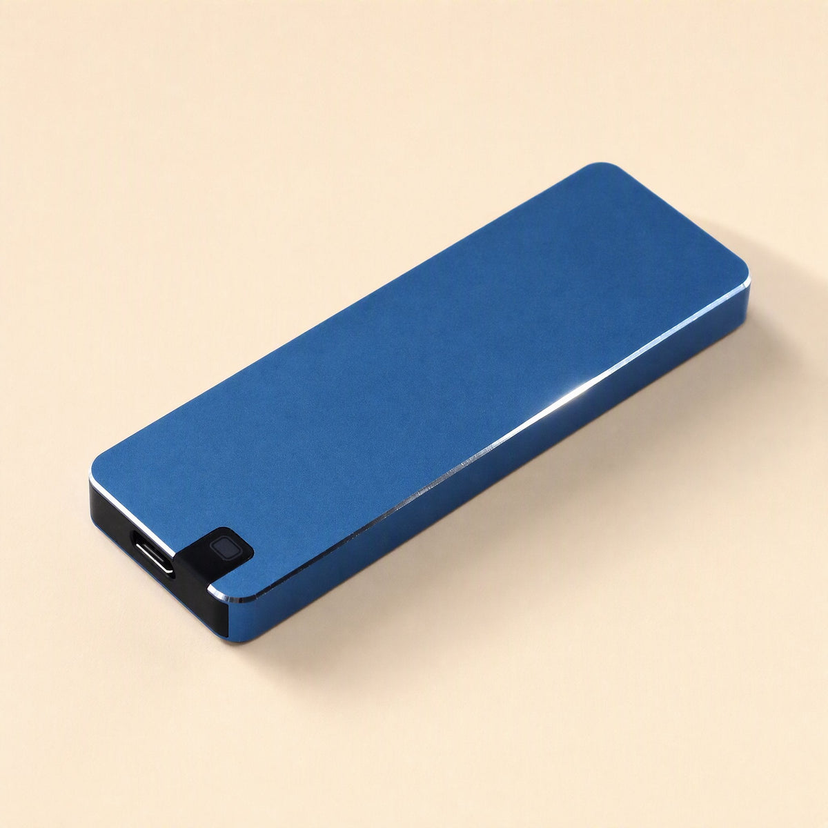 Solidvault Portable SSD – blue metal drive at an angle showing the USB-C port and small button on the black end