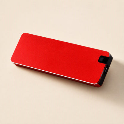 Solidvault Portable SSD – red metal drive lying flat, with the USB-C port and small button on its black end