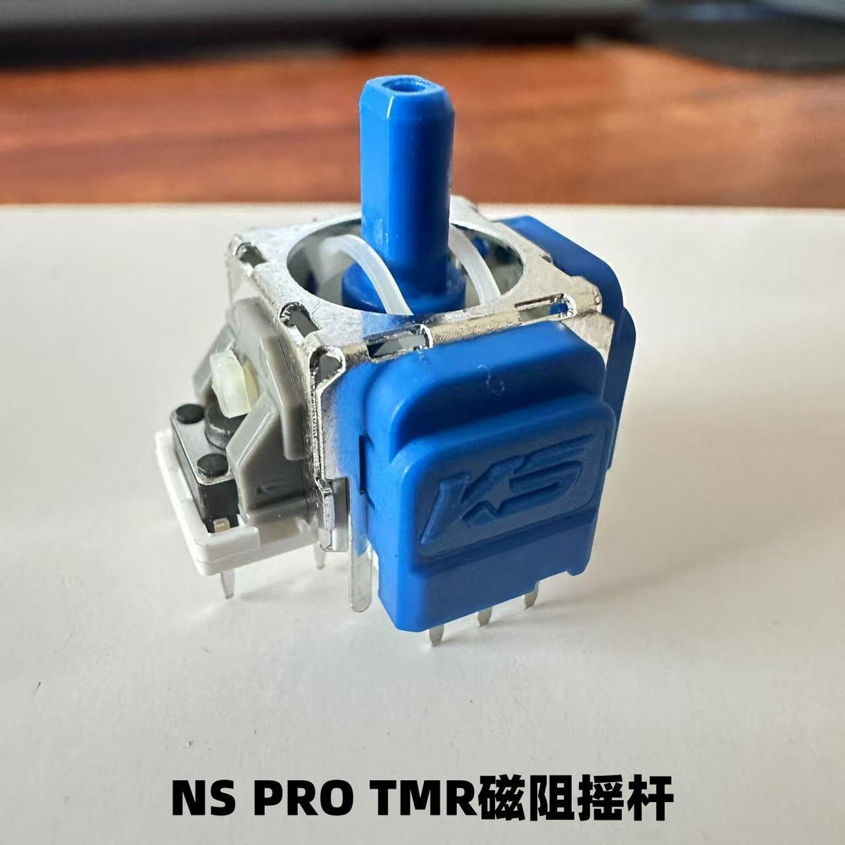 Trueaxis – Blue-stemmed TMR joystick module with blue KS casing and white tab, angled view, labeled NS PRO