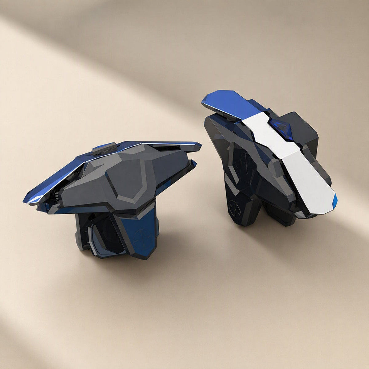 Gameglide – Pair of black and blue angular mobile game triggers on a beige background, front and side view