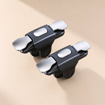 Gameglide Wireless Game Controller – two black triggers with silver metal buttons and a flat oval pad, top-down view on beige