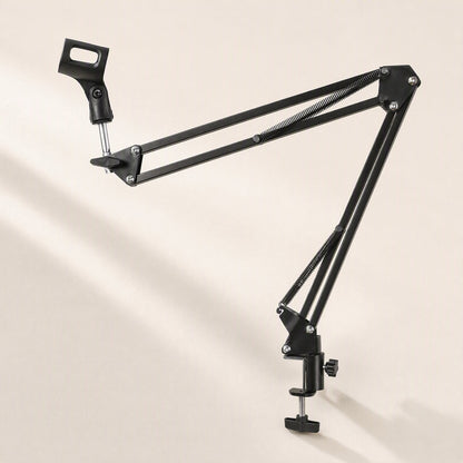 Standfold Folding Portable Microphone Stand, black boom arm extended with desk clamp on a cream backdrop