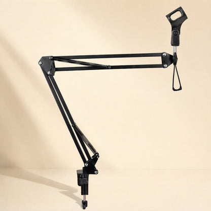 Standfold – Black microphone boom arm stretched out sideways, showing springs and clip holder on a warm beige background