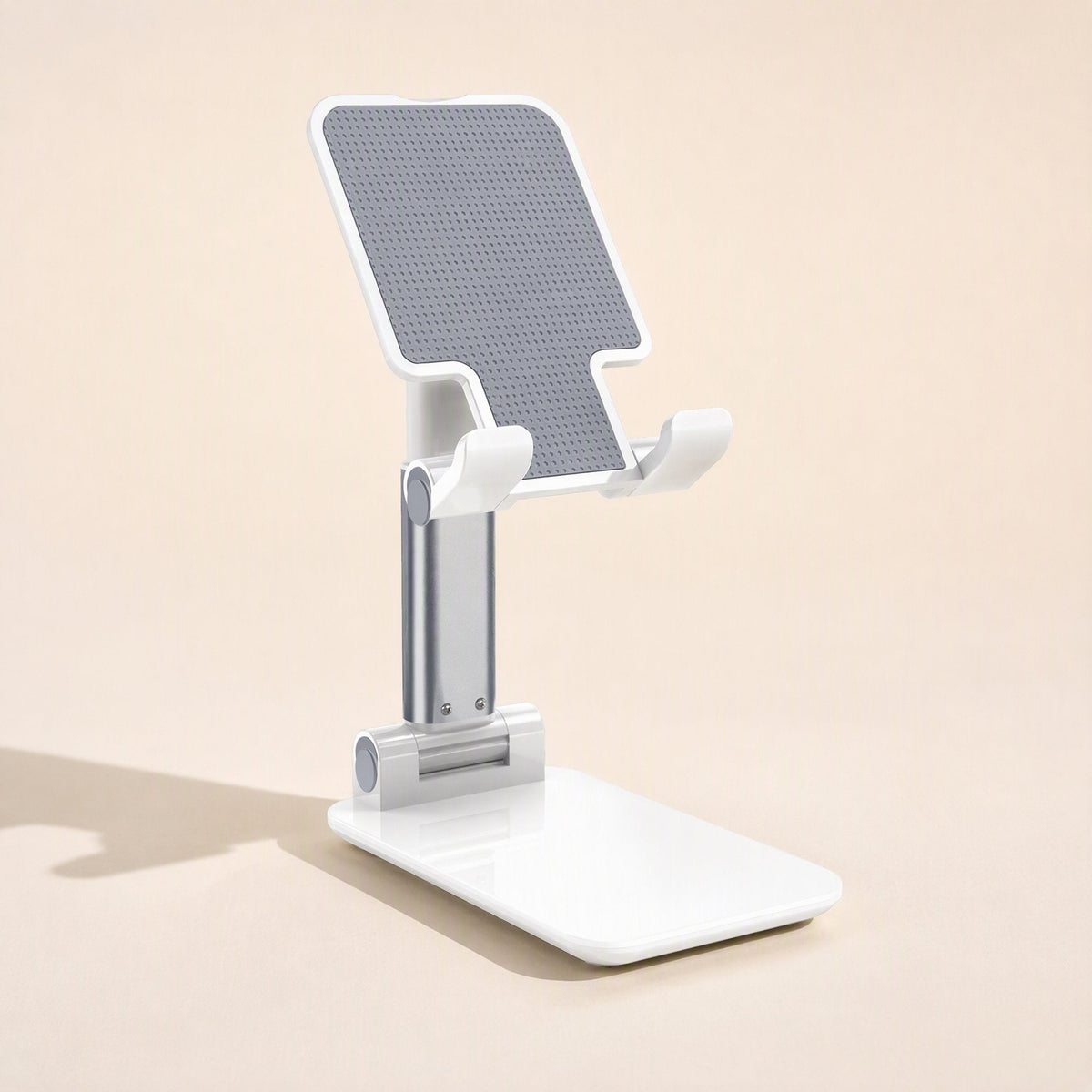 Fliprest – White holder with grey textured pad and silver stem, shown from a three-quarter angle on a plain background