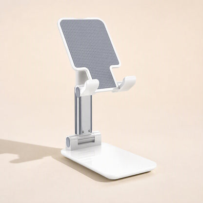 Fliprest – White holder with grey textured pad and silver stem, shown from a three-quarter angle on a plain background