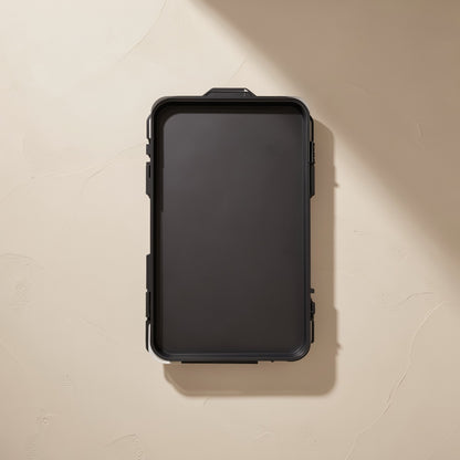 Bitbundle – Back of the black screwdriver set case with latches and a hanging tab on a cream textured wall