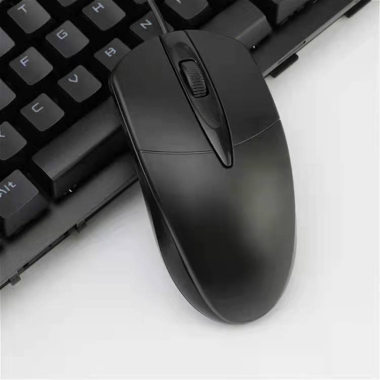 Desklick USB Wired Computer Mouse – black wired mouse from above resting next to a black keyboard on a white surface
