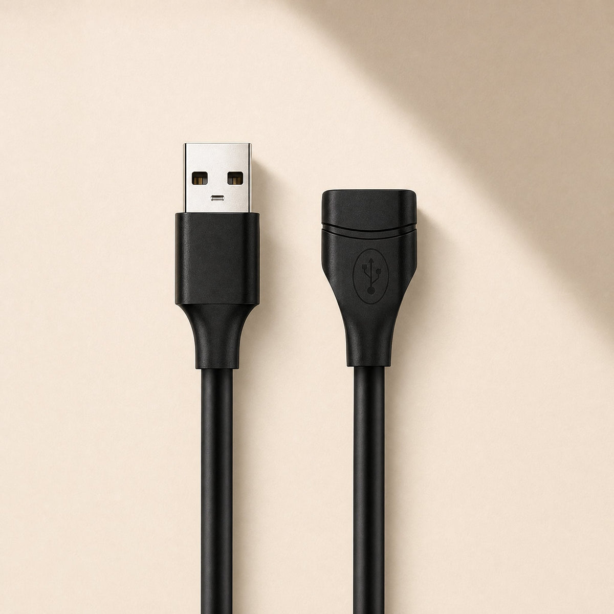 Copperreach – Black USB extension cable, male and female ends side by side, standing upright on a cream backdrop