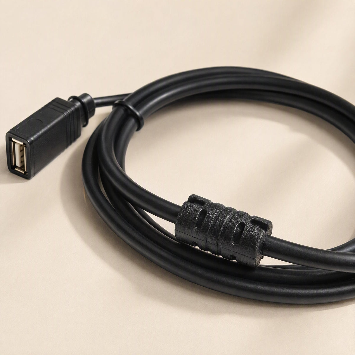 Copperreach USB Extension Cable – close-up of the female USB port end and cylindrical ferrite choke on the coiled black cable