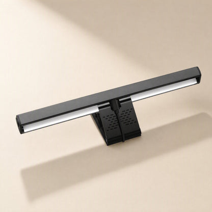 Screenglow – Underside of the black lamp bar showing the lit light strip and the vented clip stand