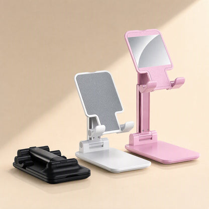 Foldgrip – White, black and pink foldable phone stands side by side, the pink one with a mirrored back panel