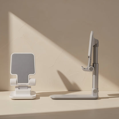Foldstand – Front and side views of white stands with silver adjustable arm and grey grip pad against a beige wall