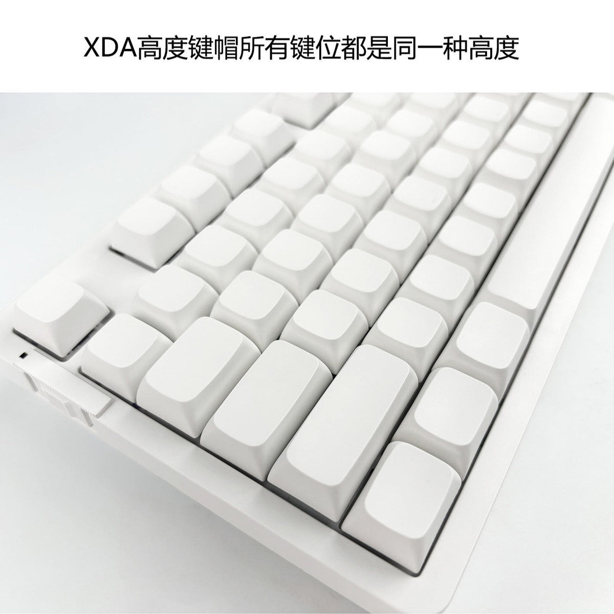 Xdalux – Angled close-up of white blank XDA-profile keycaps in uniform height on a white keyboard