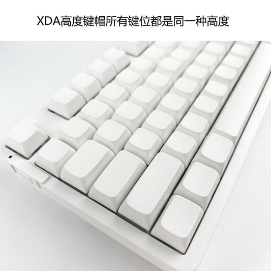 Xdalux – Angled close-up of white blank XDA-profile keycaps in uniform height on a white keyboard