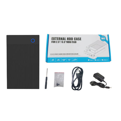 Shellbox – Black enclosure with blue ring button beside retail box, screwdriver, screw bag, USB cable and power adapter