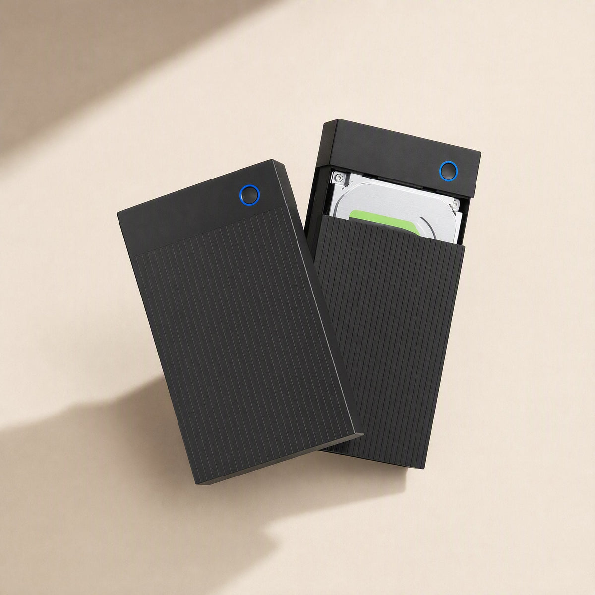 Portshield – Two black enclosures side by side, one with its sleeve slid open to show a hard drive inside