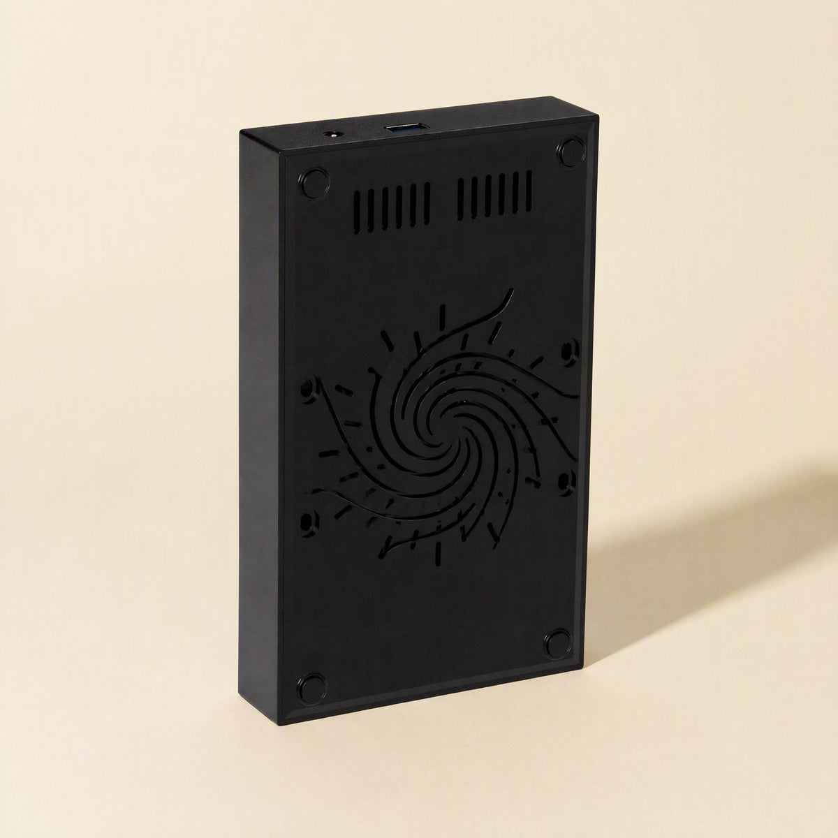 Portshield – Back panel of the black enclosure with vent slots, spiral pattern and four rubber feet