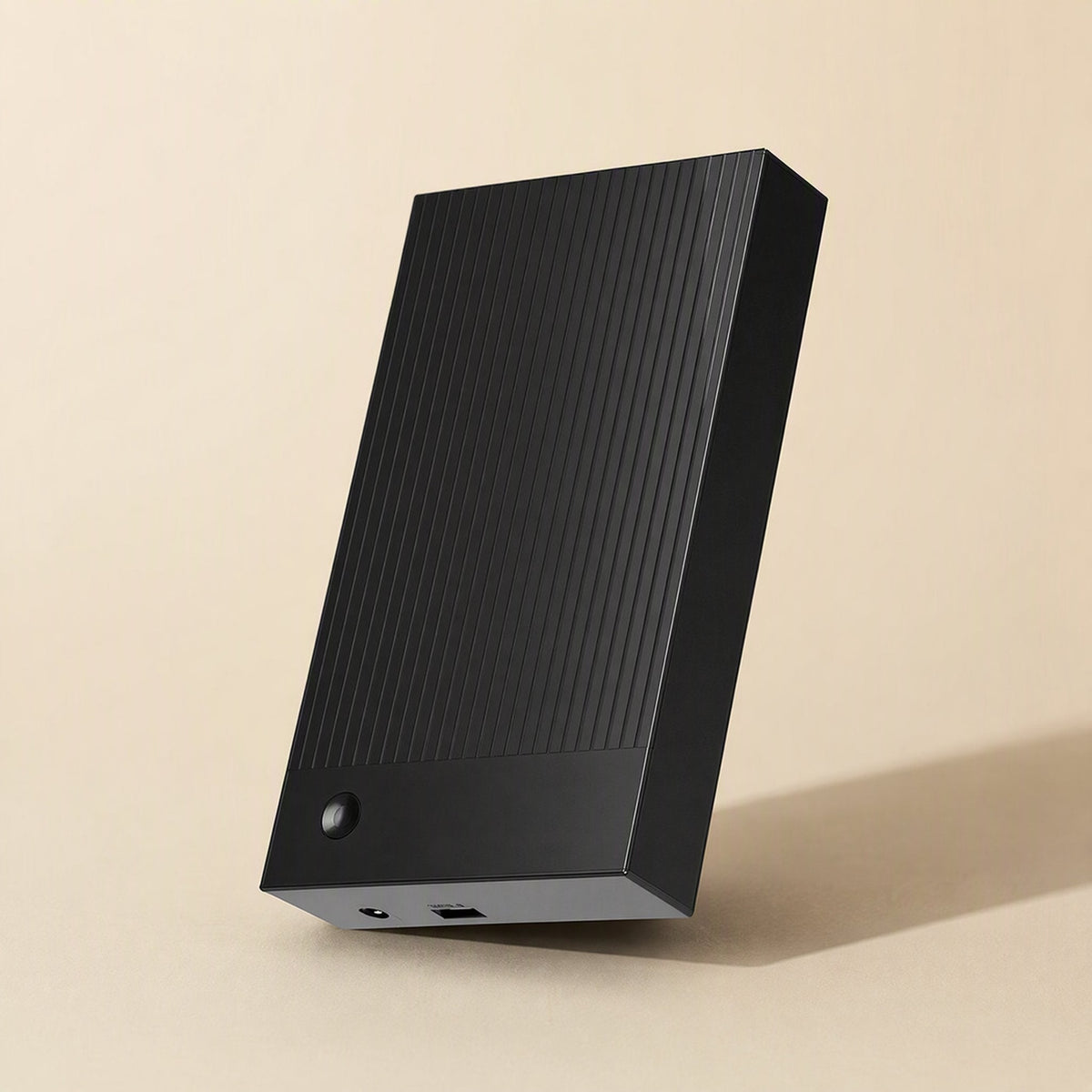 Portshield – Black ridged enclosure standing on one edge, showing the power jack and USB port on the end