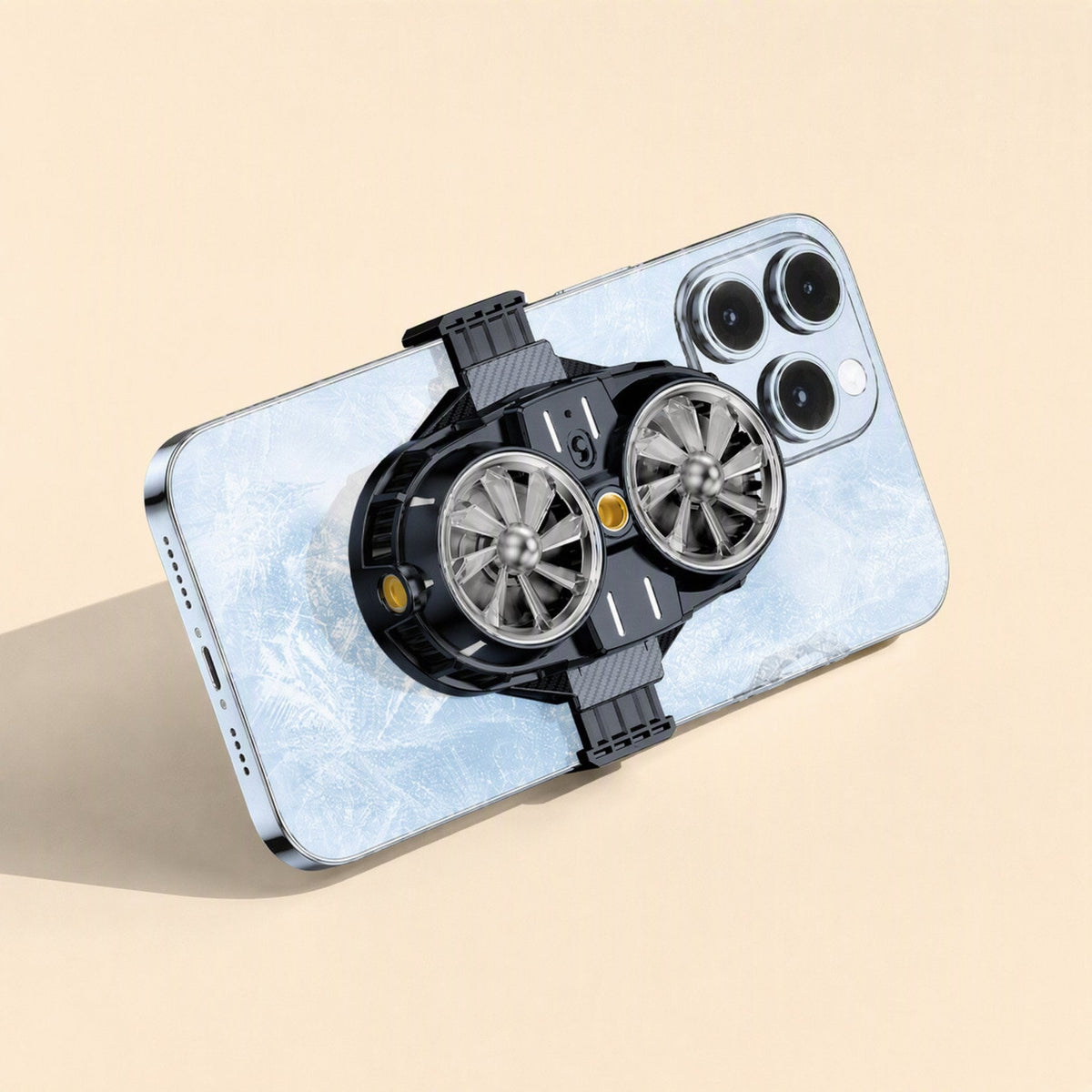 Coolcove – Phone with frost-pattern back and the radiator clamped on, two fans and a gold center button visible